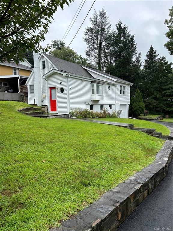 a front view of house with yard and green space