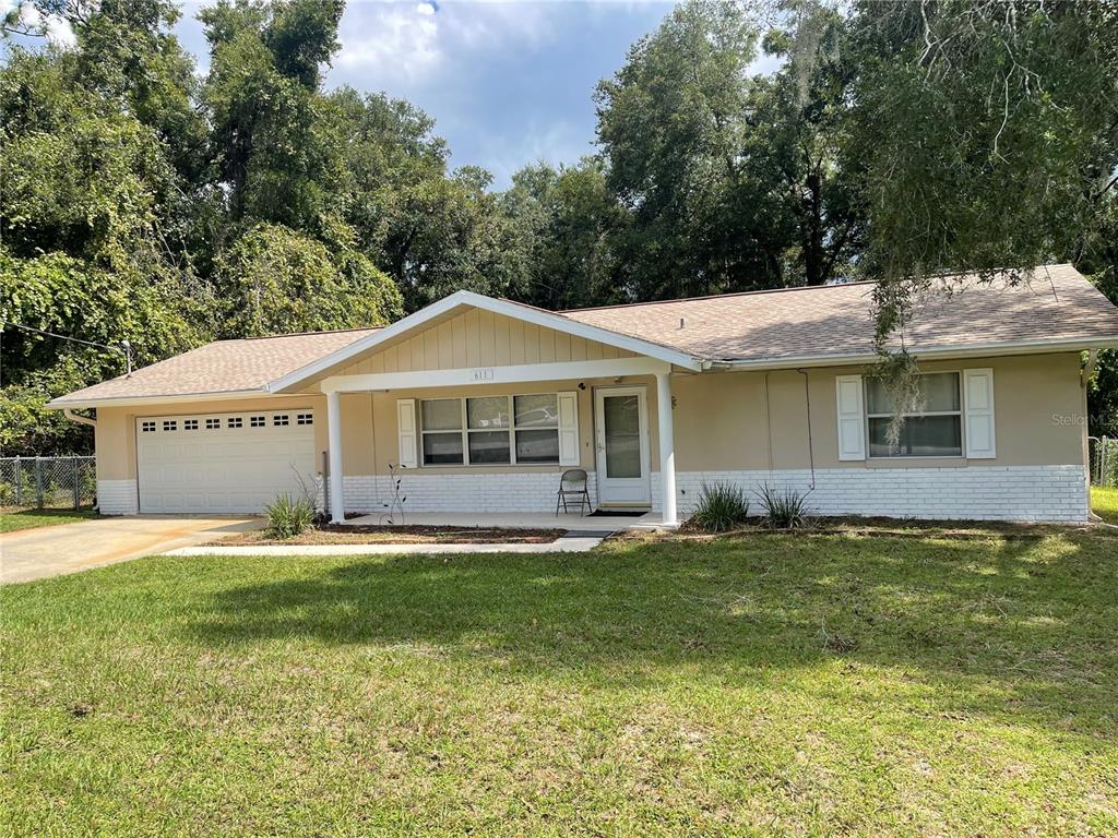 a front view of a house with a yard and porch