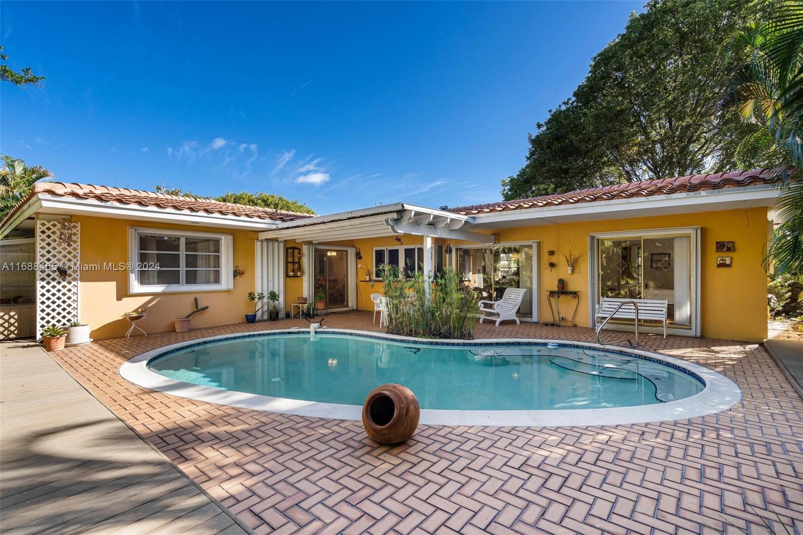 a view of a house with swimming pool and sitting area