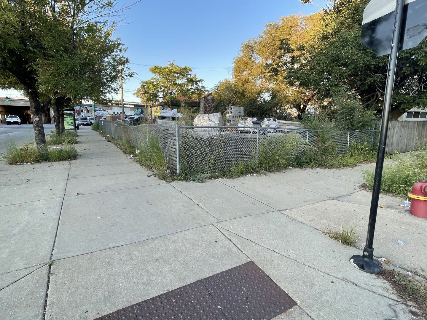 a view of a street with benches sitting next to a road