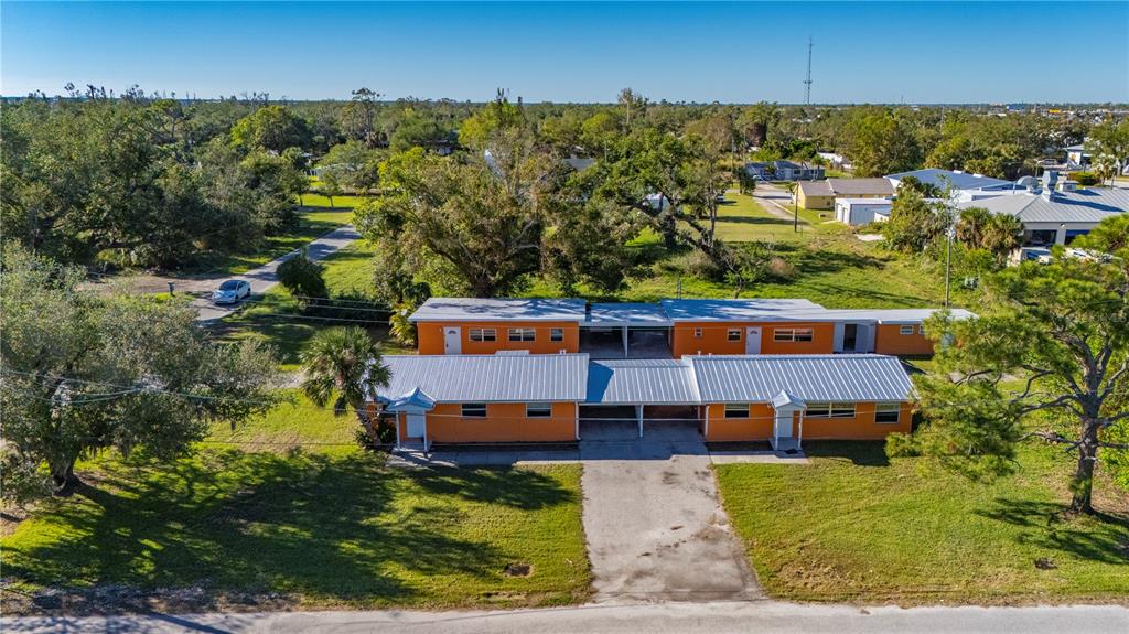 an aerial view of a house with a yard basket ball court and outdoor seating