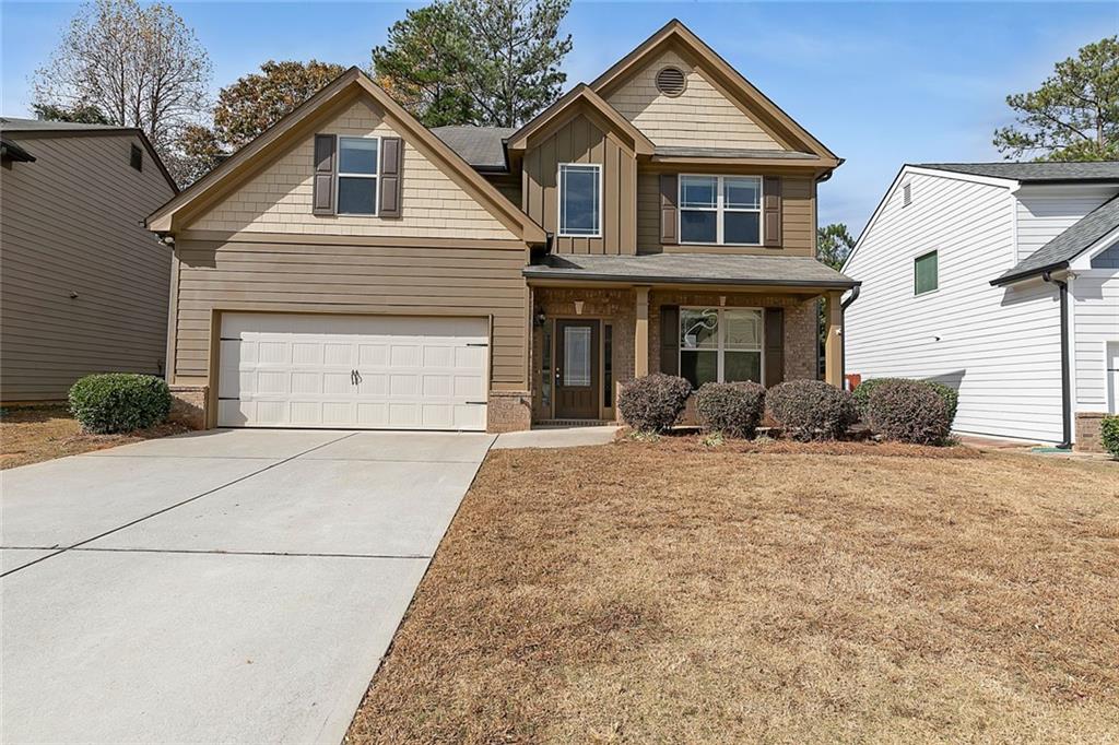 a front view of a house with a yard and garage