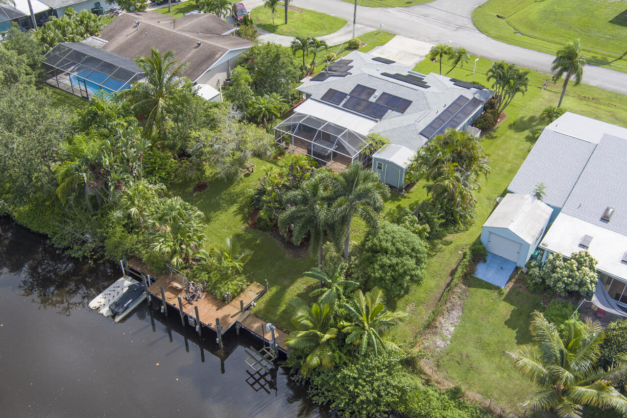 an aerial view of a house with a yard basket ball court and a fountain