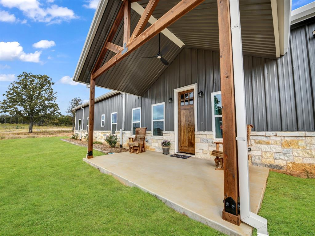 a view of a house with backyard porch and sitting area