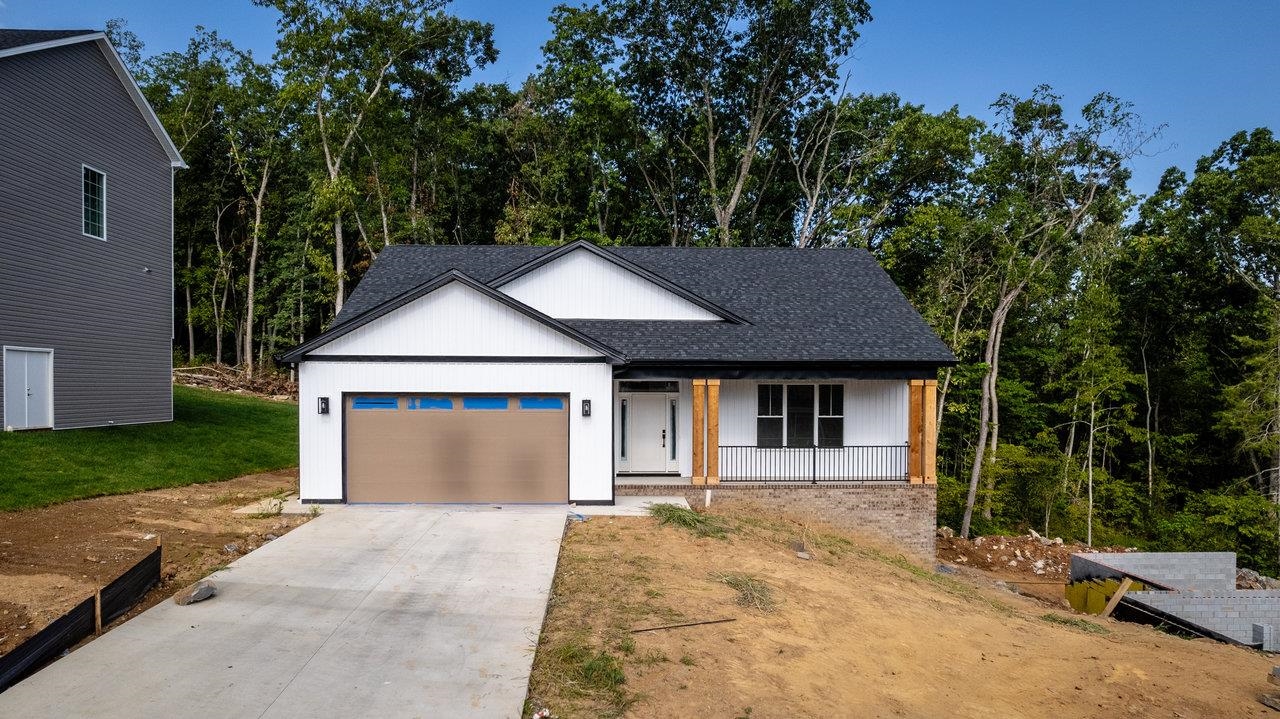 front view of a house with a yard and an trees