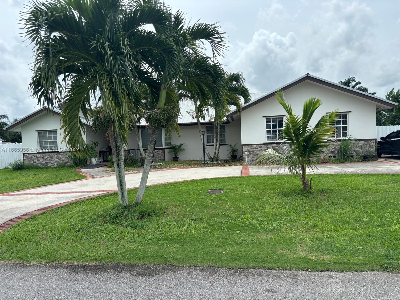 a house that has a tree in front of it