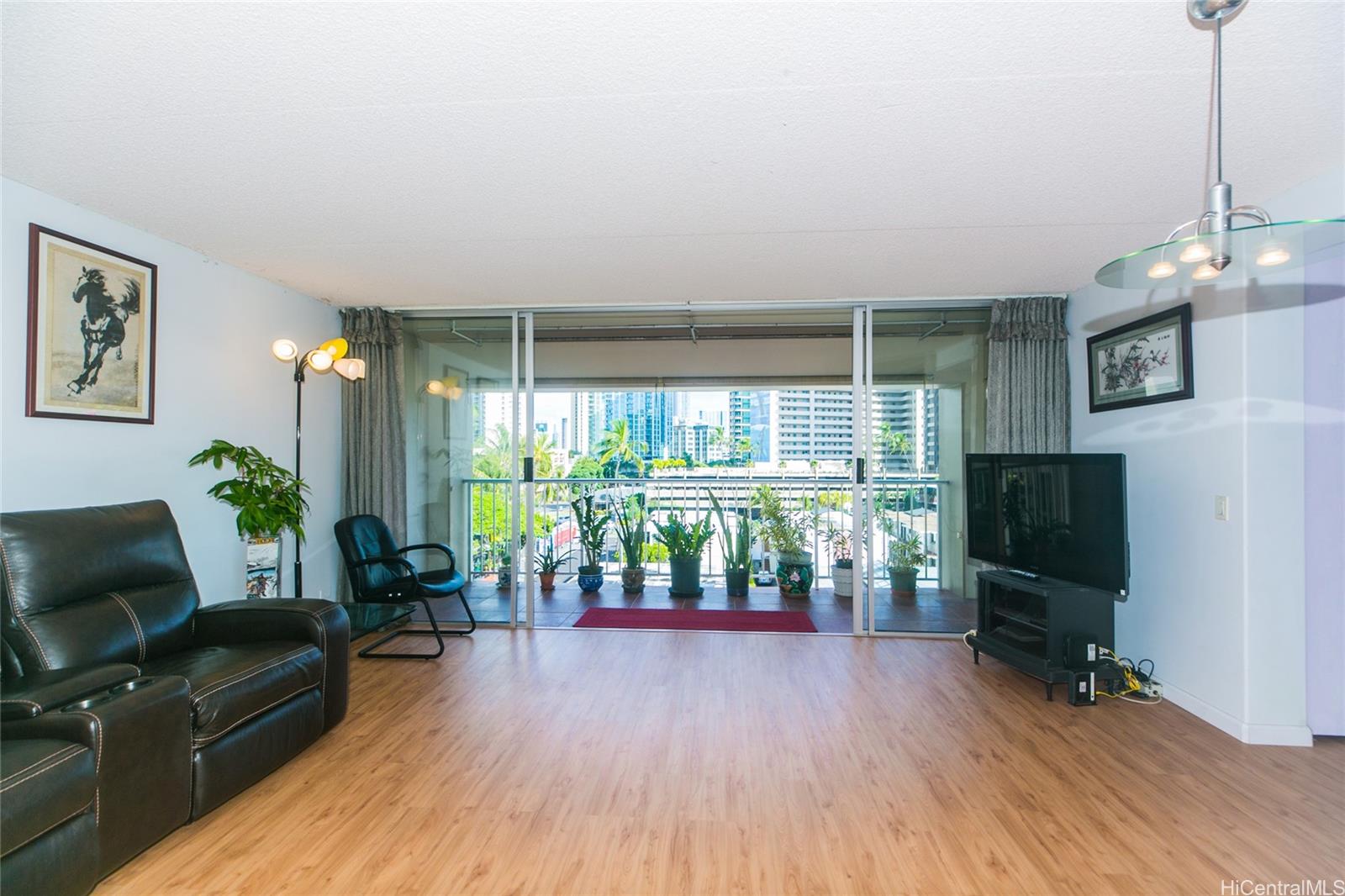 a livingroom with furniture wooden floor and a flat screen tv