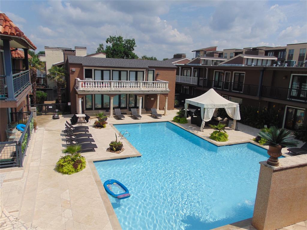 a view of swimming pool with outdoor seating and a garden