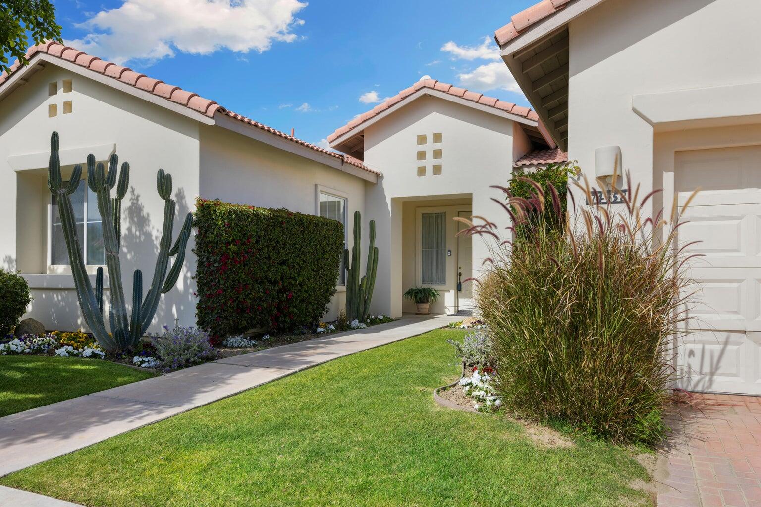 a front view of a house with garden