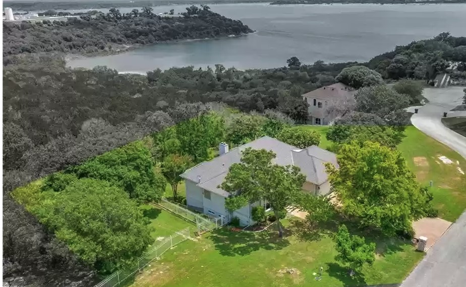 an aerial view of residential house with outdoor space and lake view