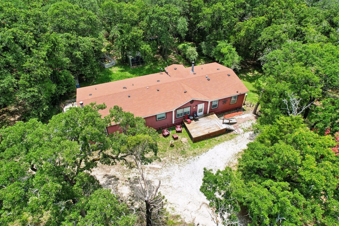 an aerial view of a house with yard swimming pool and outdoor seating