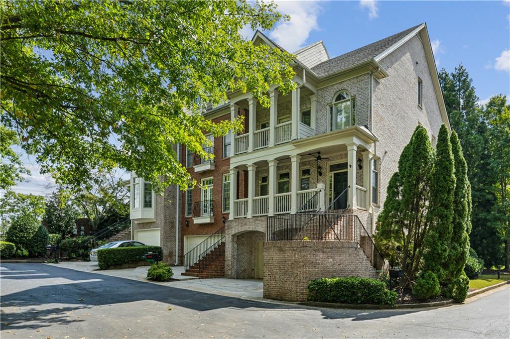 a front view of a house with a yard and potted plants