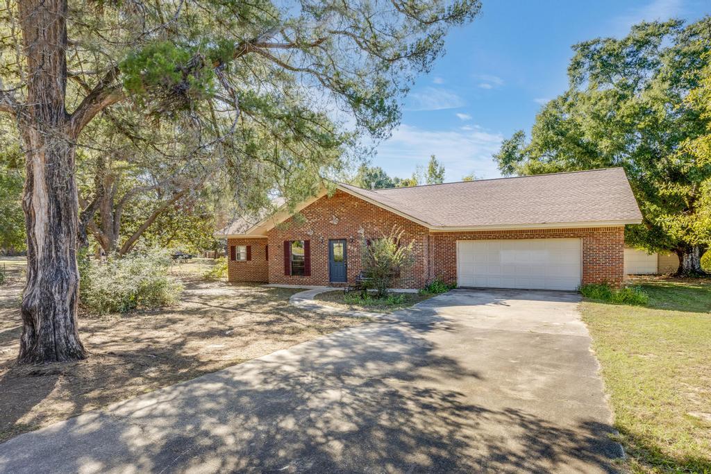 a big house with large trees and a big yard