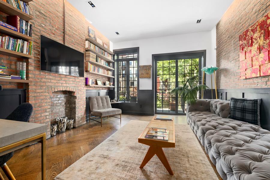 a living room with fireplace furniture and a flat screen tv