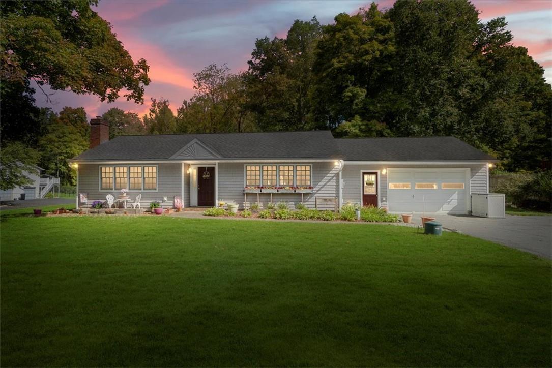 a front view of house with yard and green space