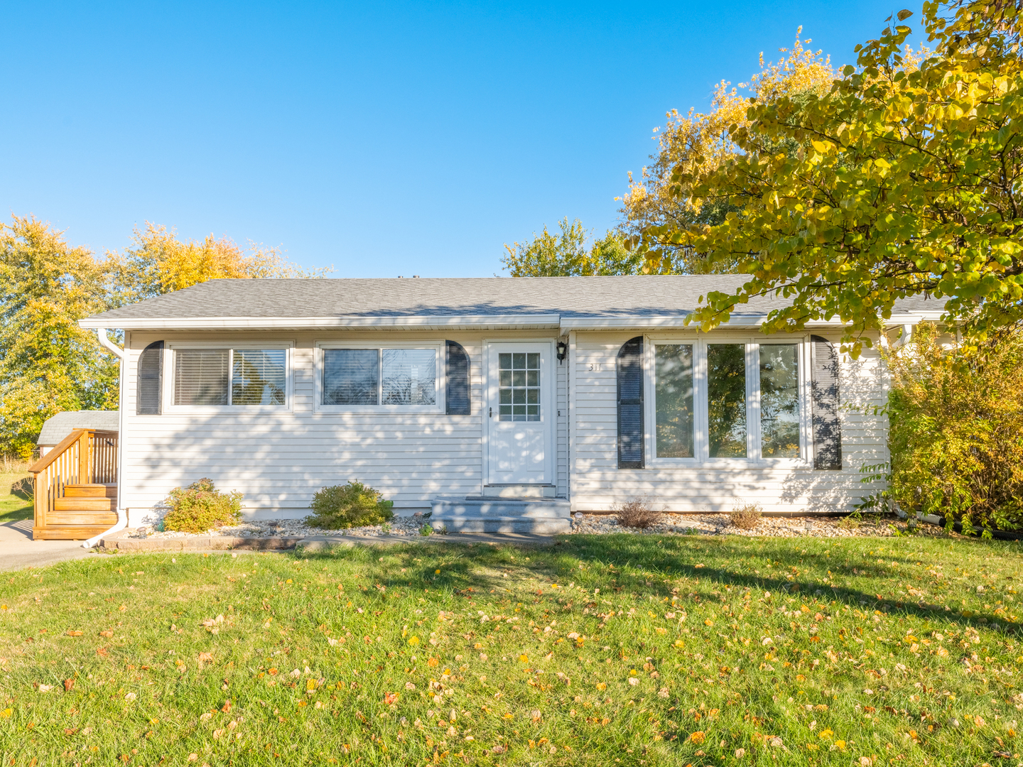 a front view of a house with swimming pool and porch with furniture