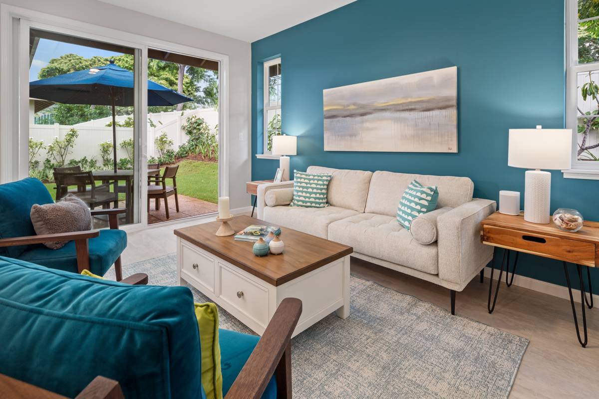 a living room with furniture and a floor to ceiling window