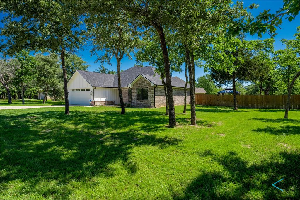 a front view of a house with yard and green space