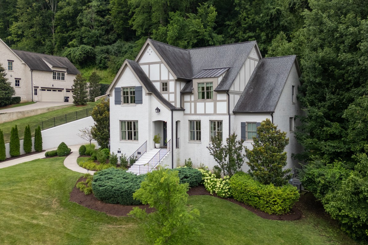 a aerial view of a house with yard and green space