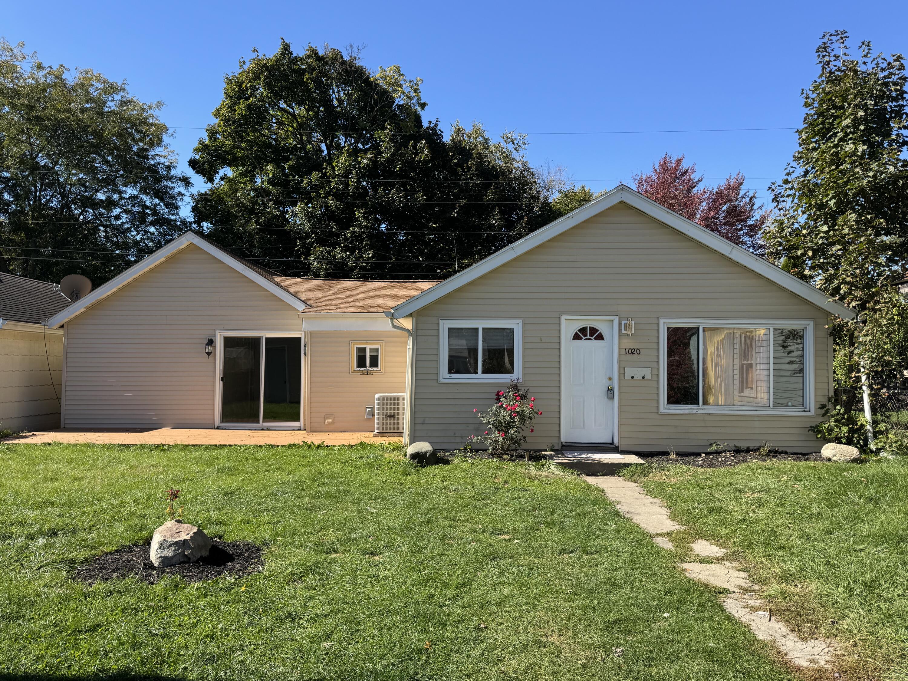 a front view of house with yard and green space