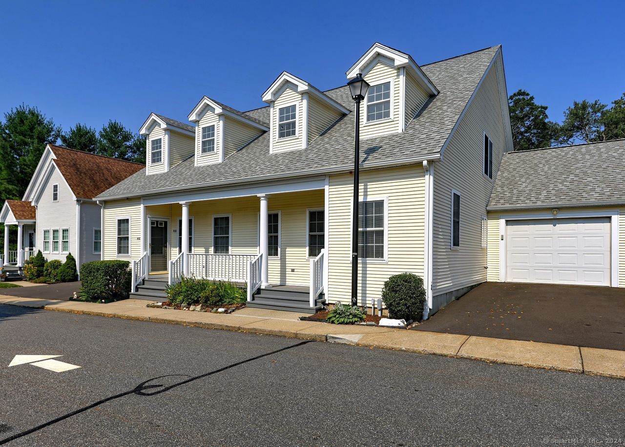 a front view of a house with a garden and garage