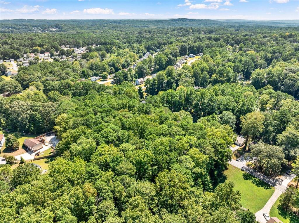 an aerial view of a houses with a yard