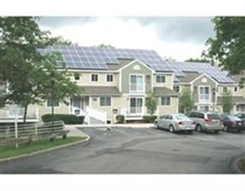 a front view of a residential apartment building with a yard