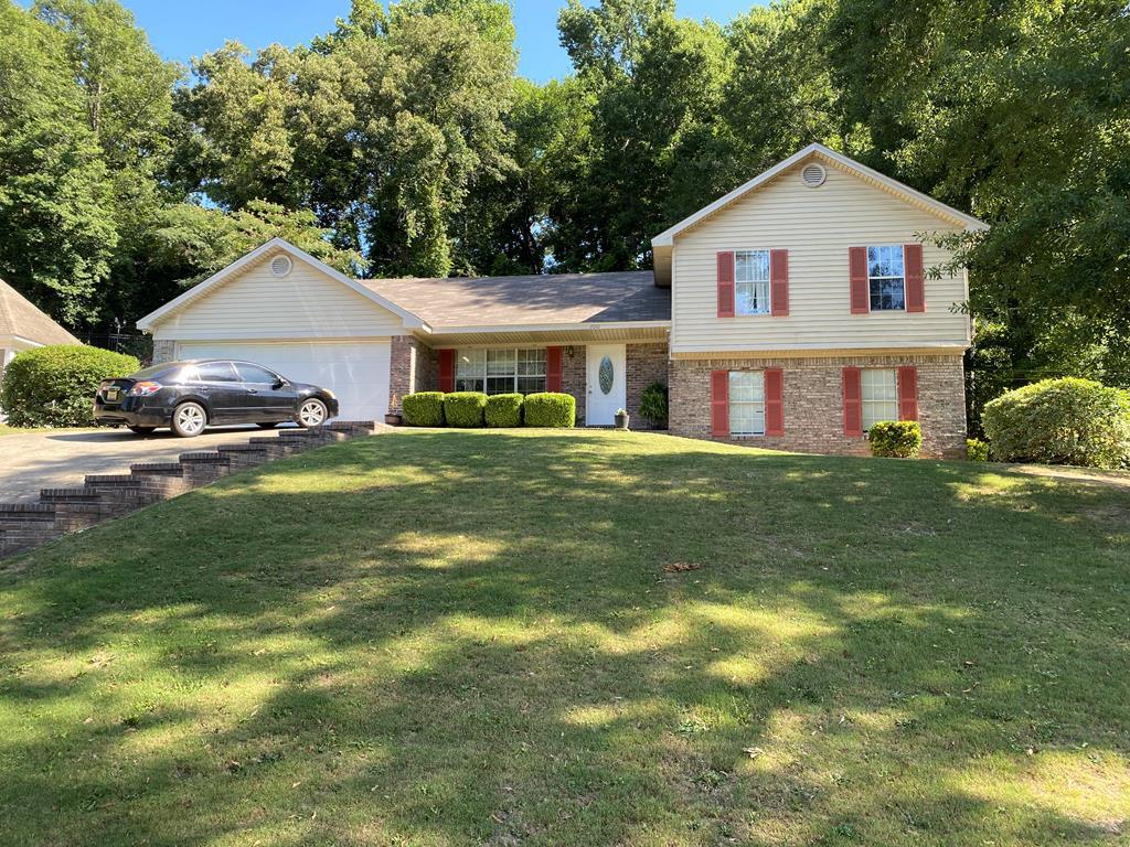 a front view of a house with a yard