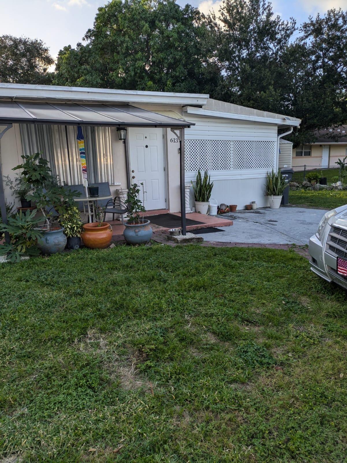 a view of backyard with outdoor seating and green space