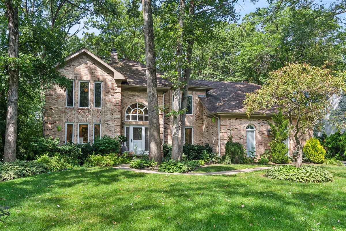 a front view of house with yard and green space