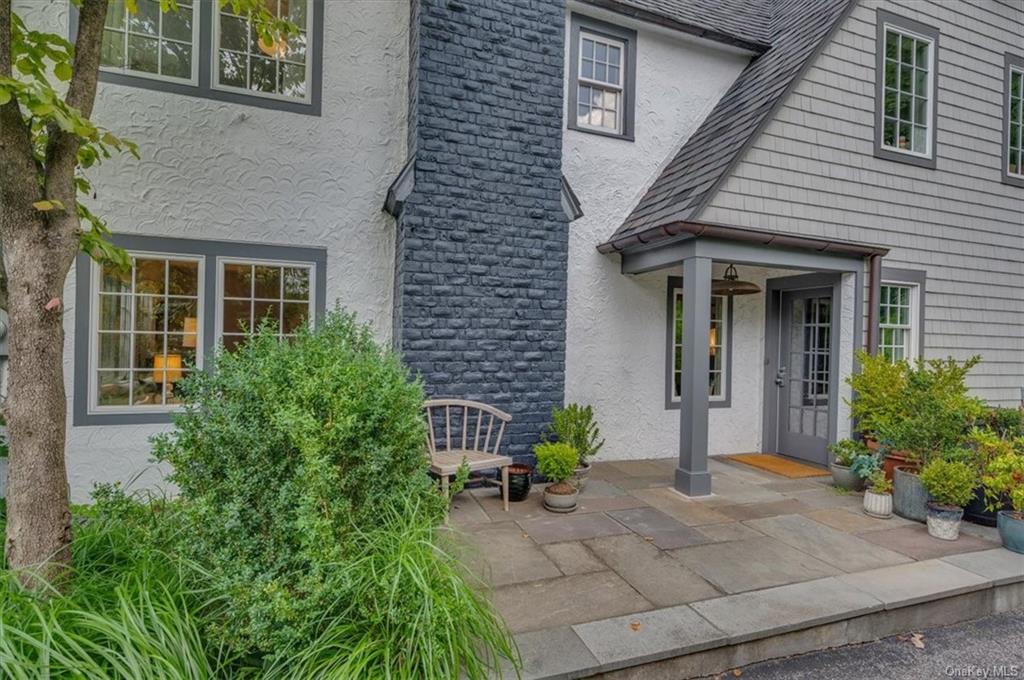 a front view of a house with potted plants