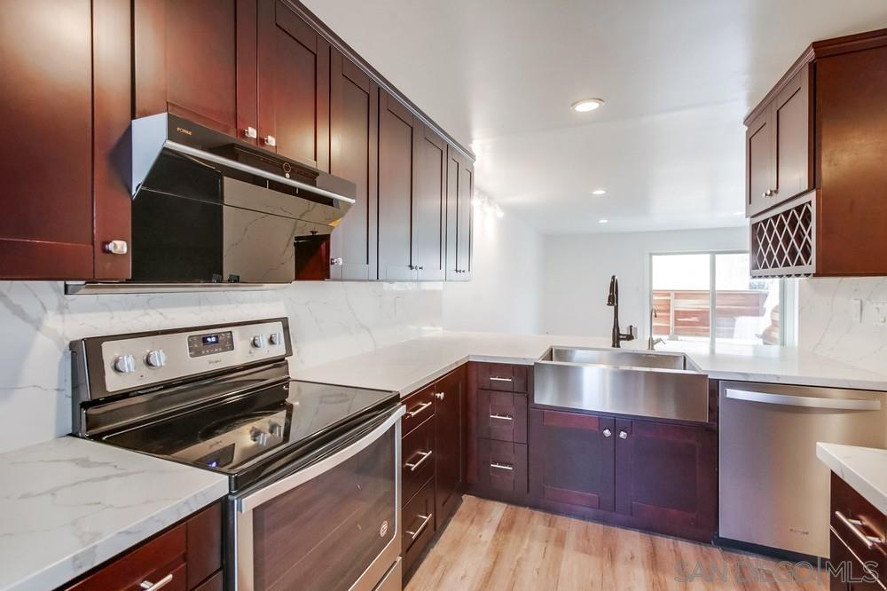 a kitchen with a sink stove and microwave