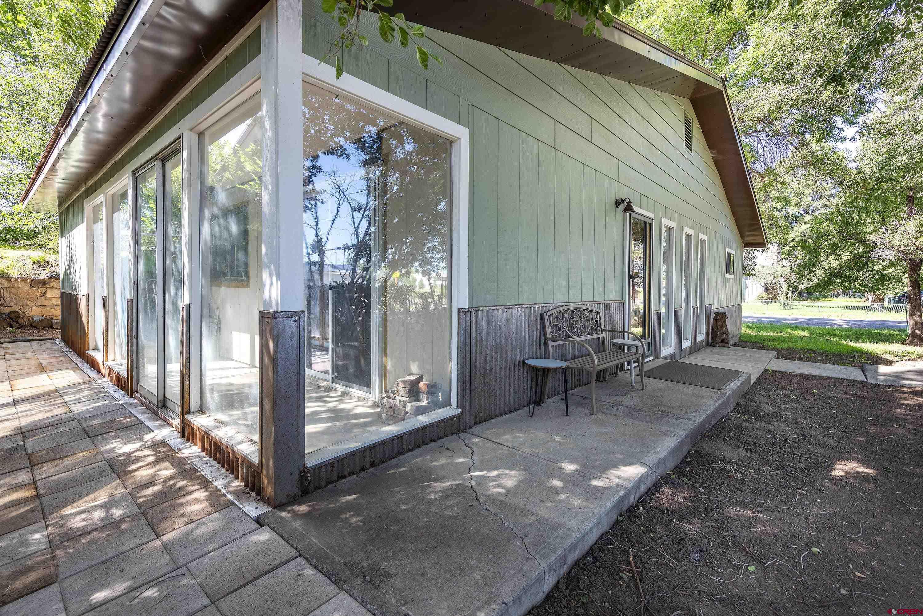 a view of a porch with chairs and backyard