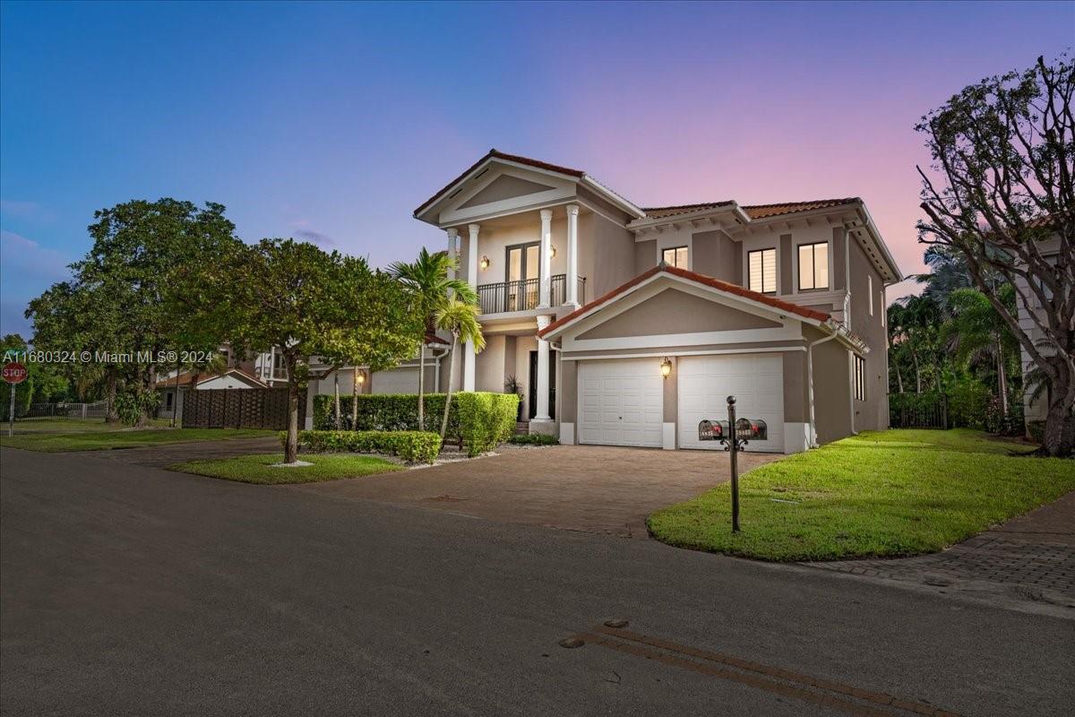 a front view of a house with a yard and garage