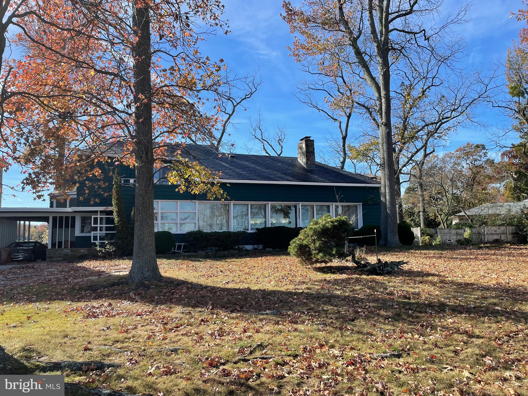 a view of a house with a yard covered in snow