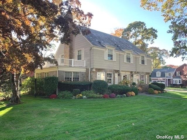 a front view of house with yard and green space