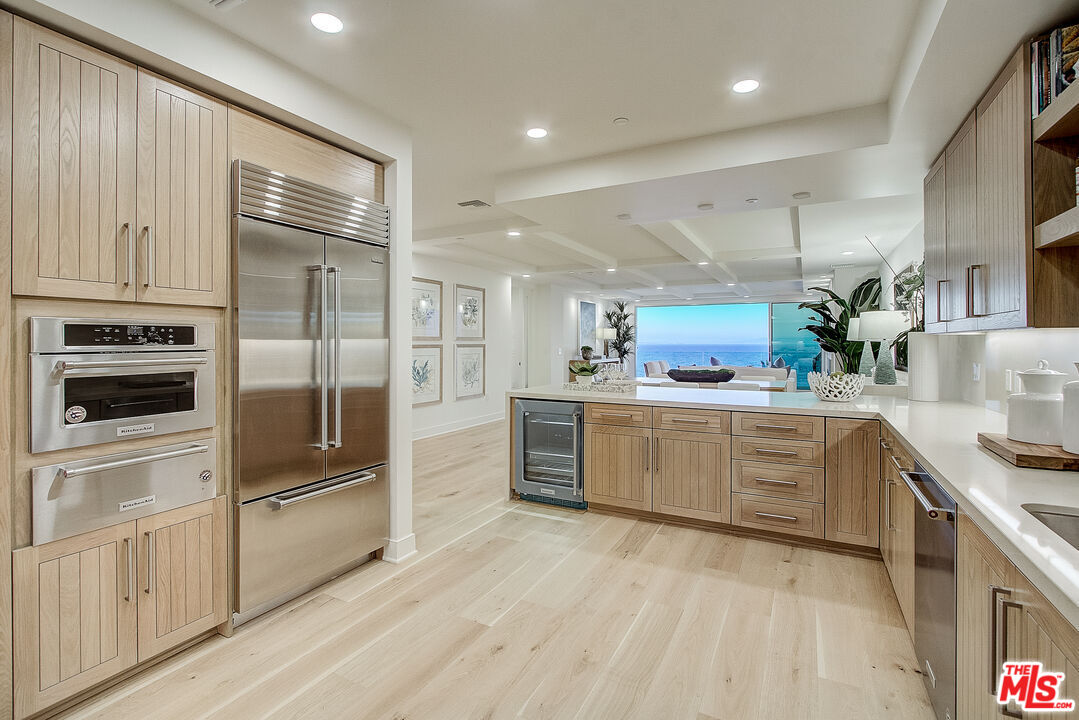 a large kitchen with cabinets and stainless steel appliances