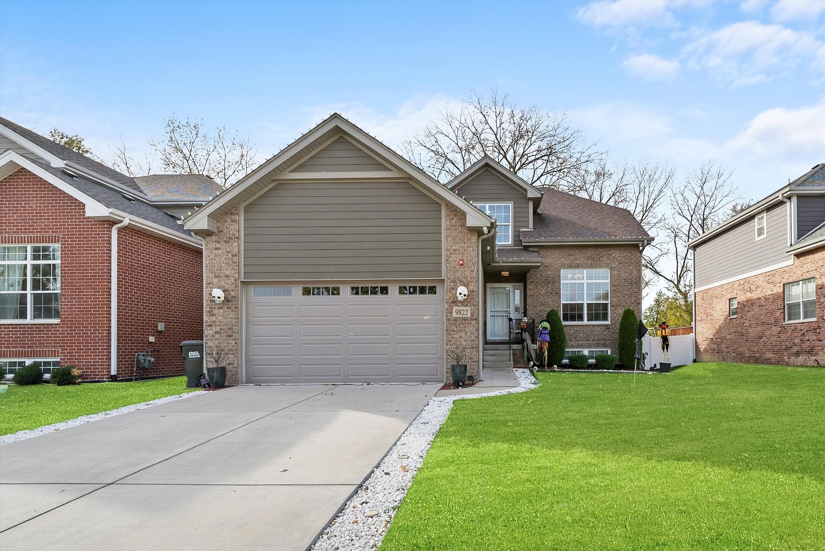 a front view of a house with a yard and garage