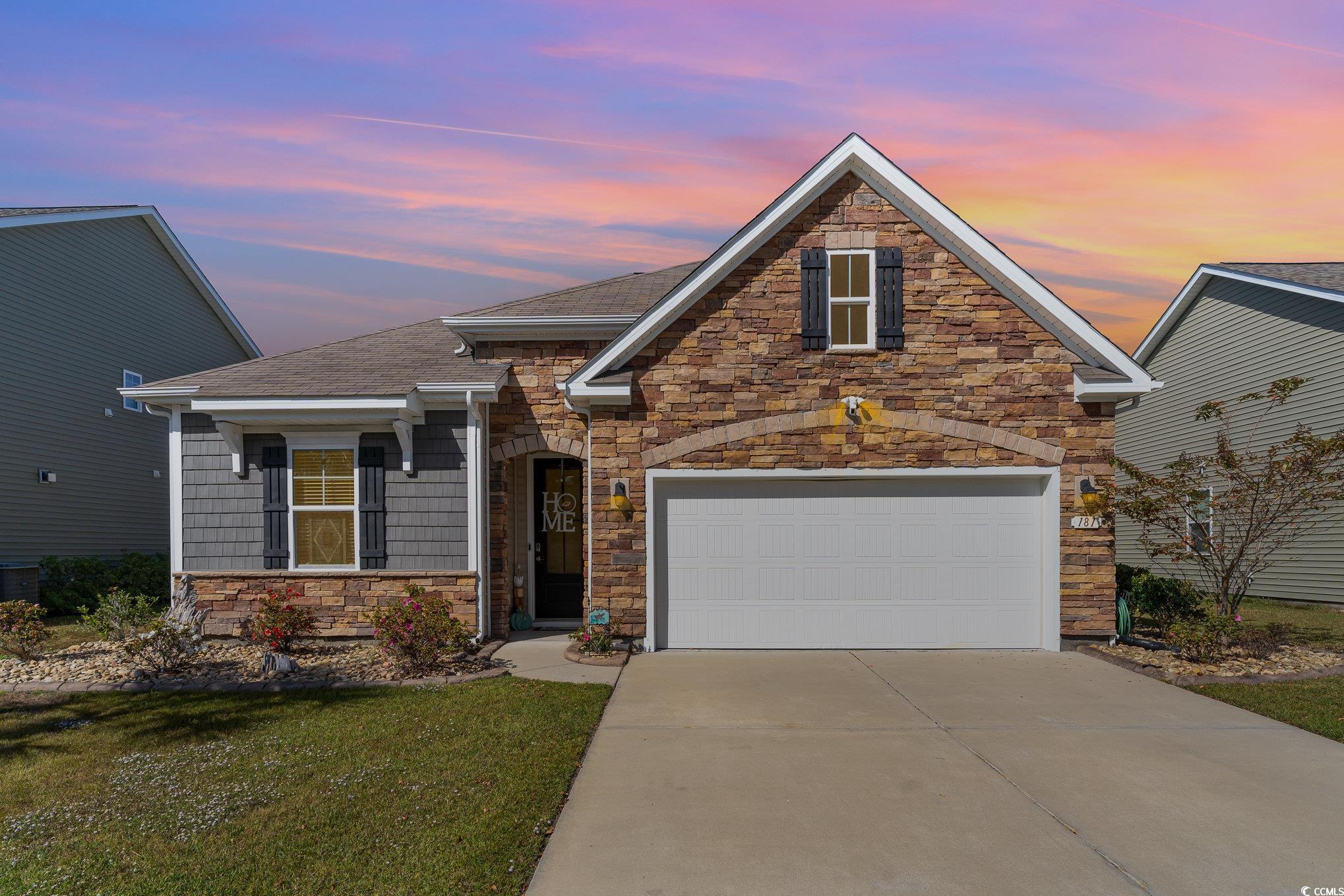 View of front of house with a lawn and a garage