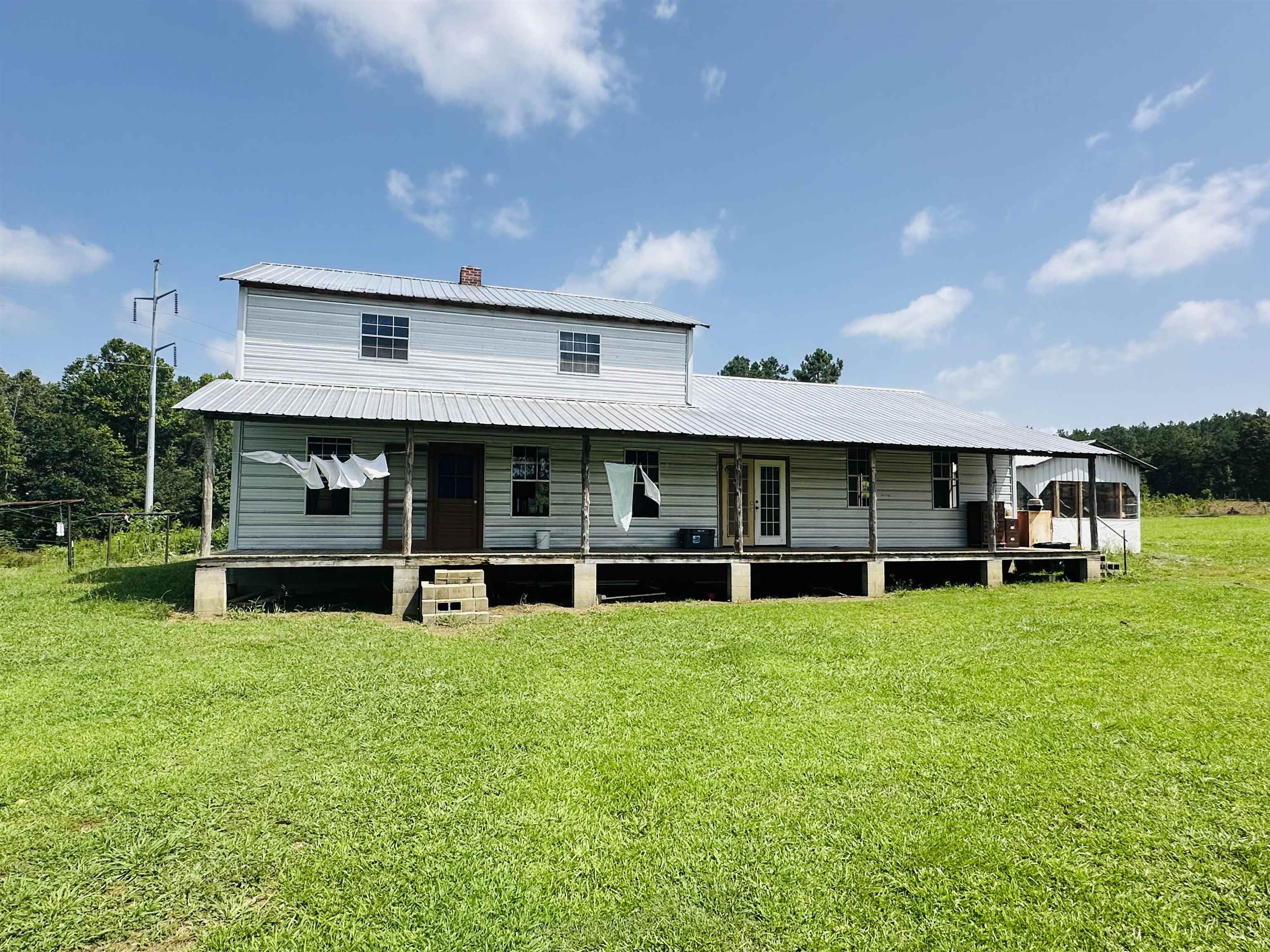 a view of a house with a yard and sitting area