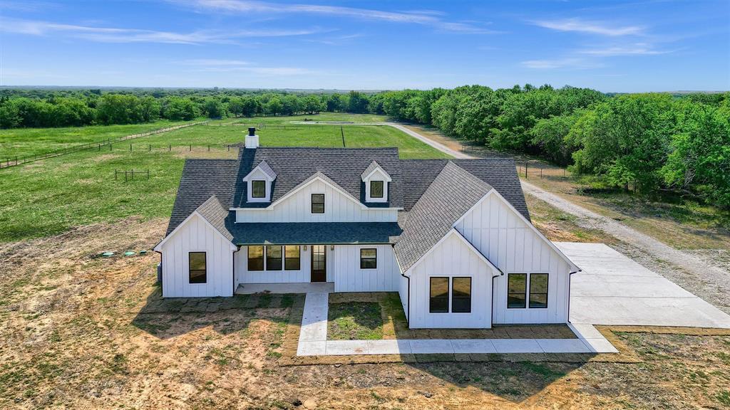 a aerial view of a house next to a yard