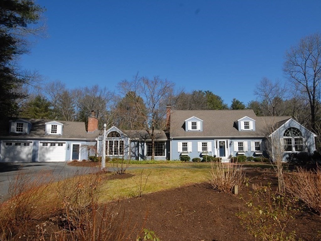 a view of a big house with a big yard and large tree