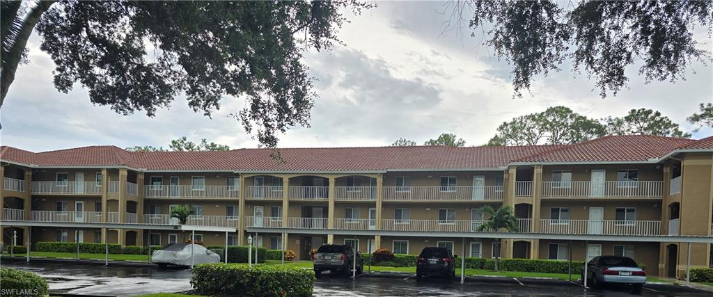 a front view of a residential apartment building with a yard