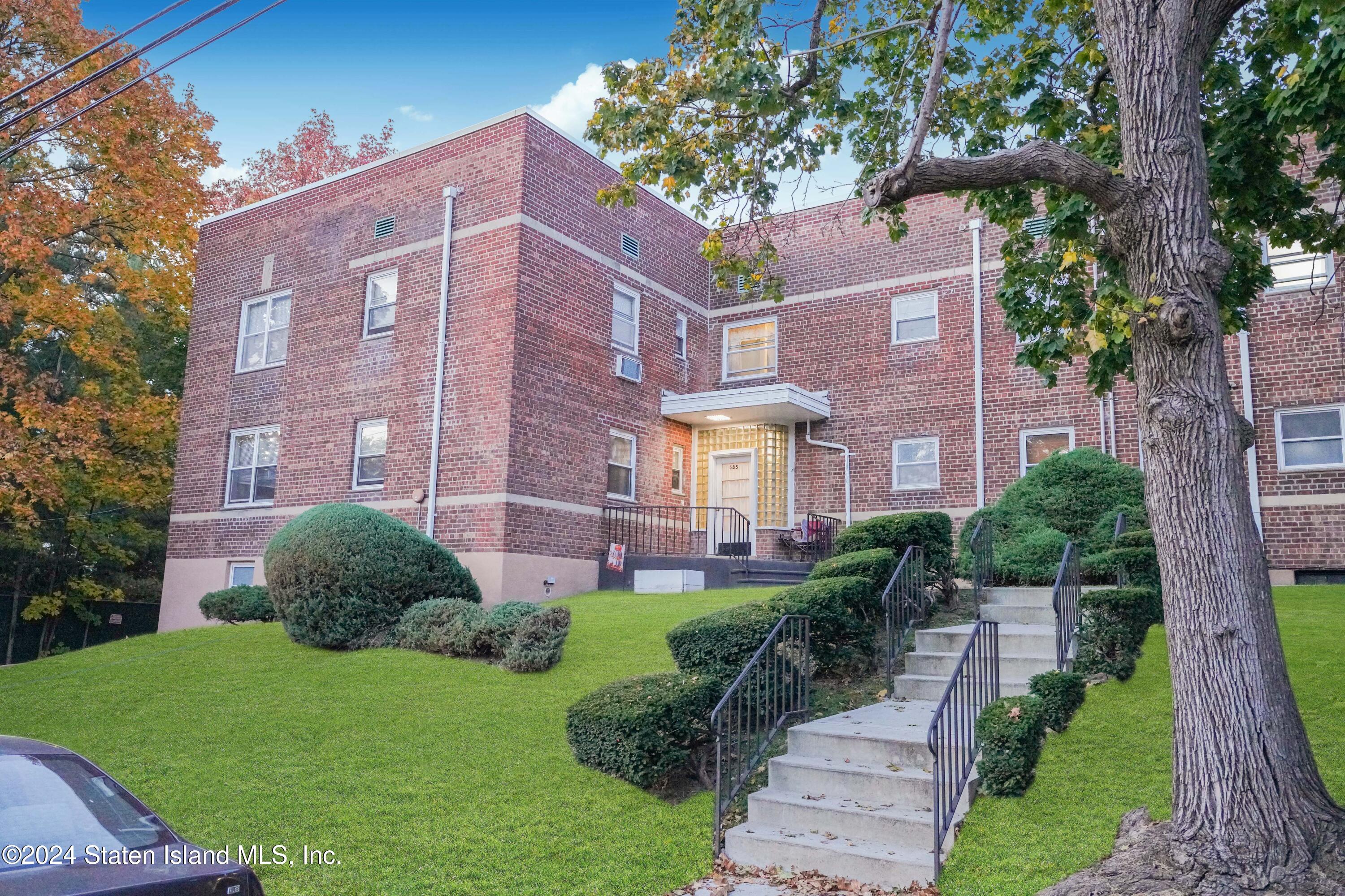 a view of a brick building next to a yard