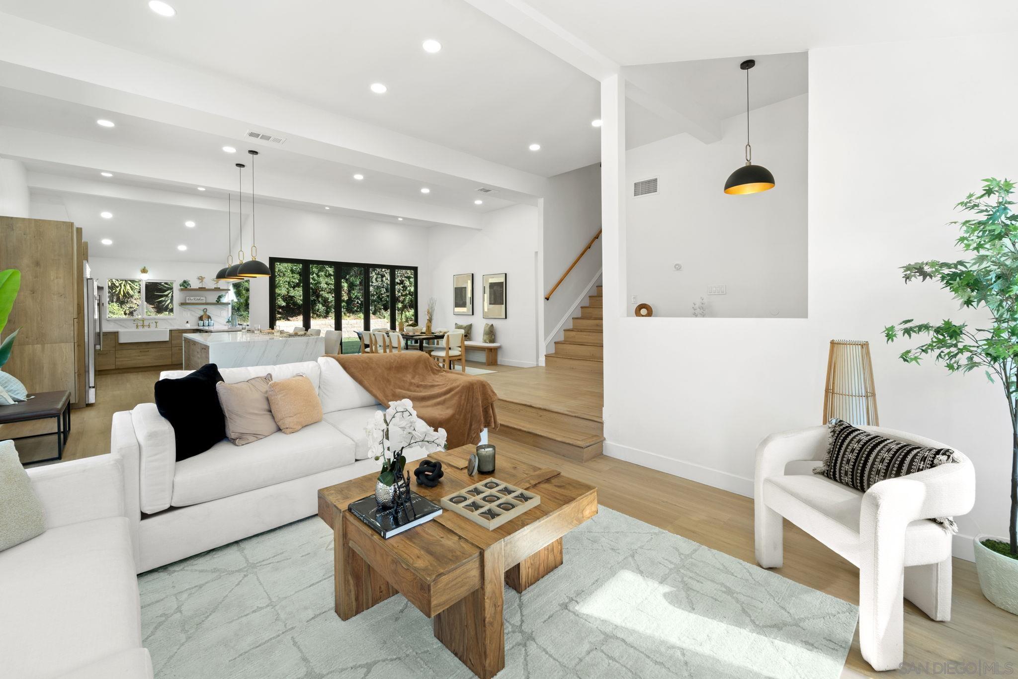 a living room with furniture and a potted plant