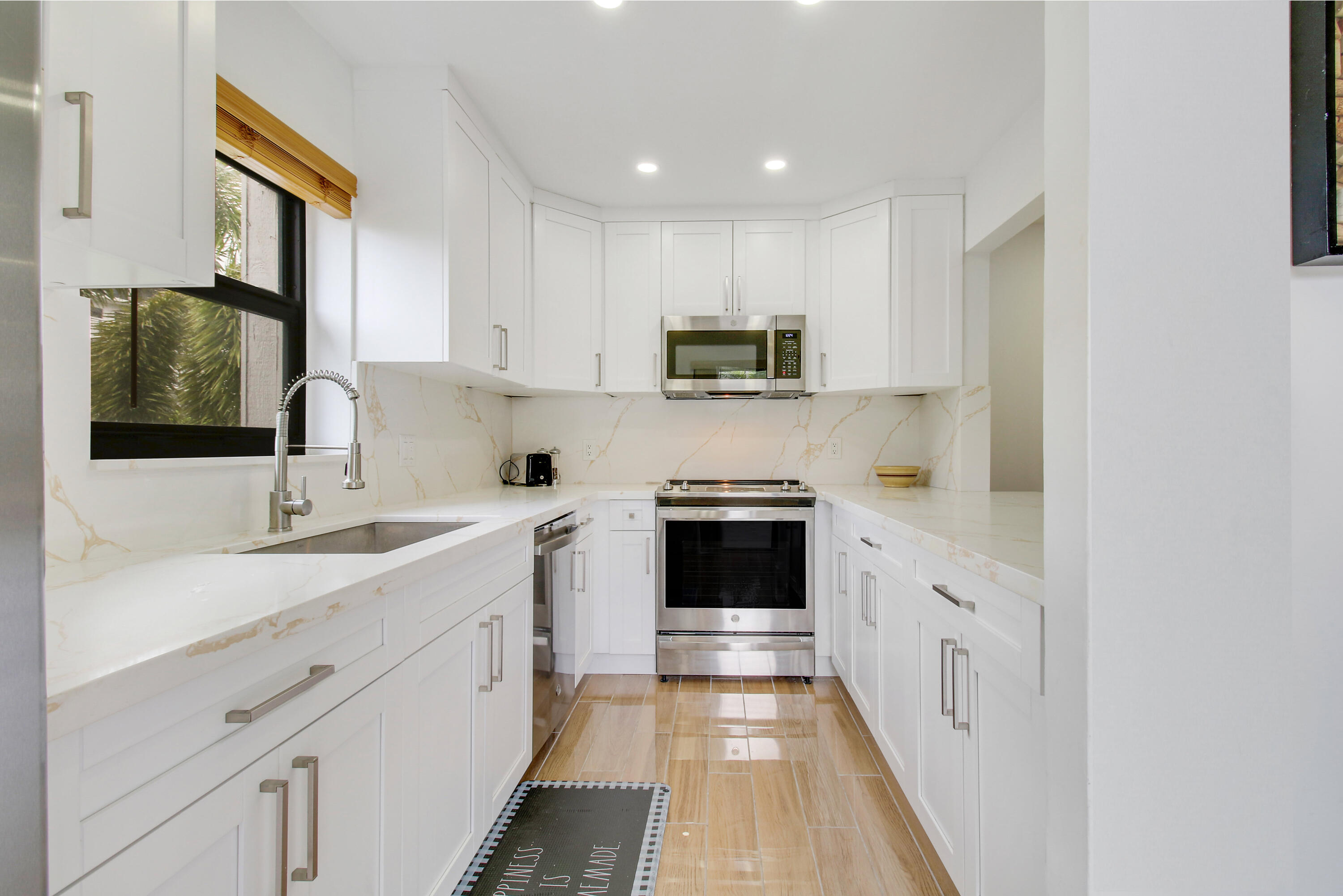 a kitchen with stainless steel appliances a sink stove and cabinets