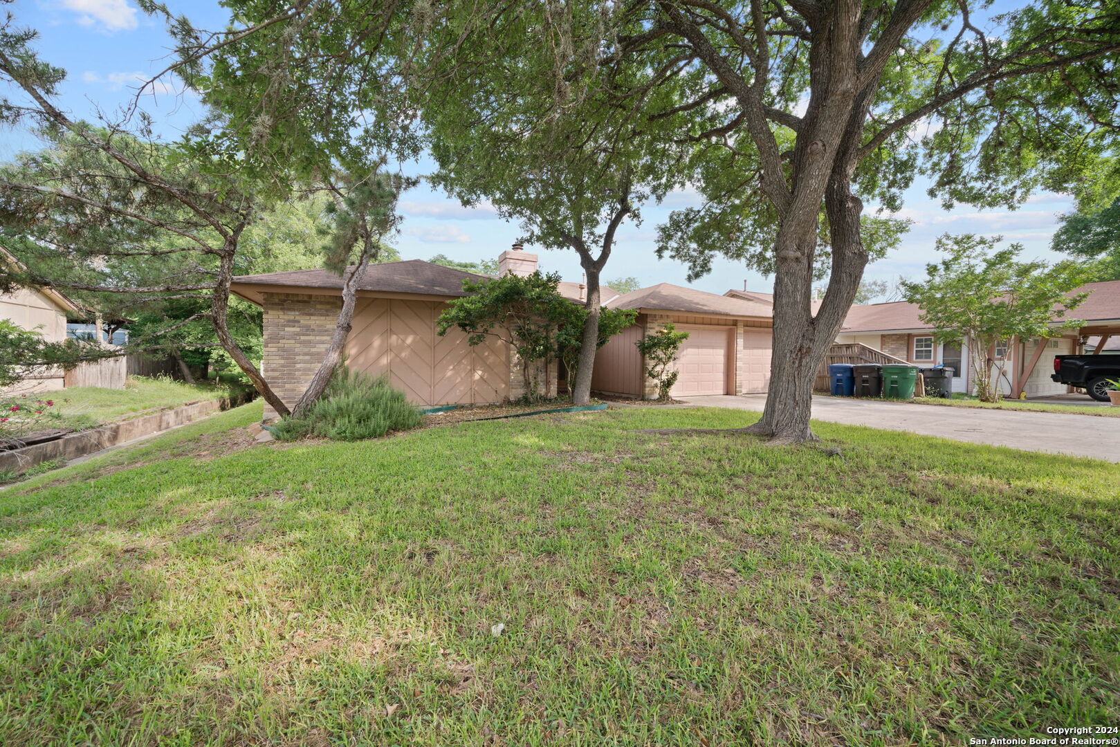 a view of a house with yard and a tree