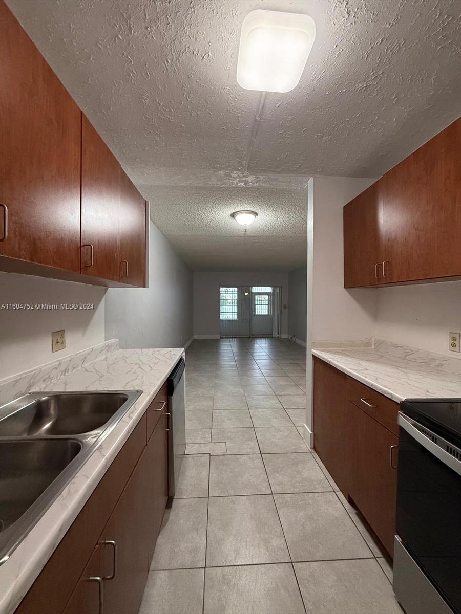 a kitchen with a sink and a stove top oven