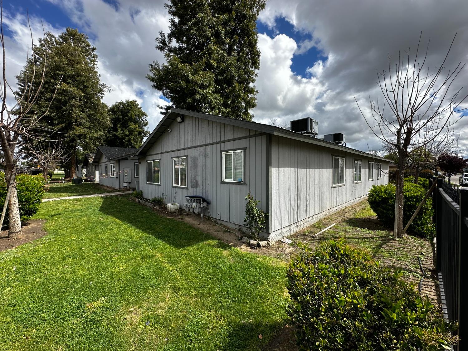 a view of a house with backyard and sitting area