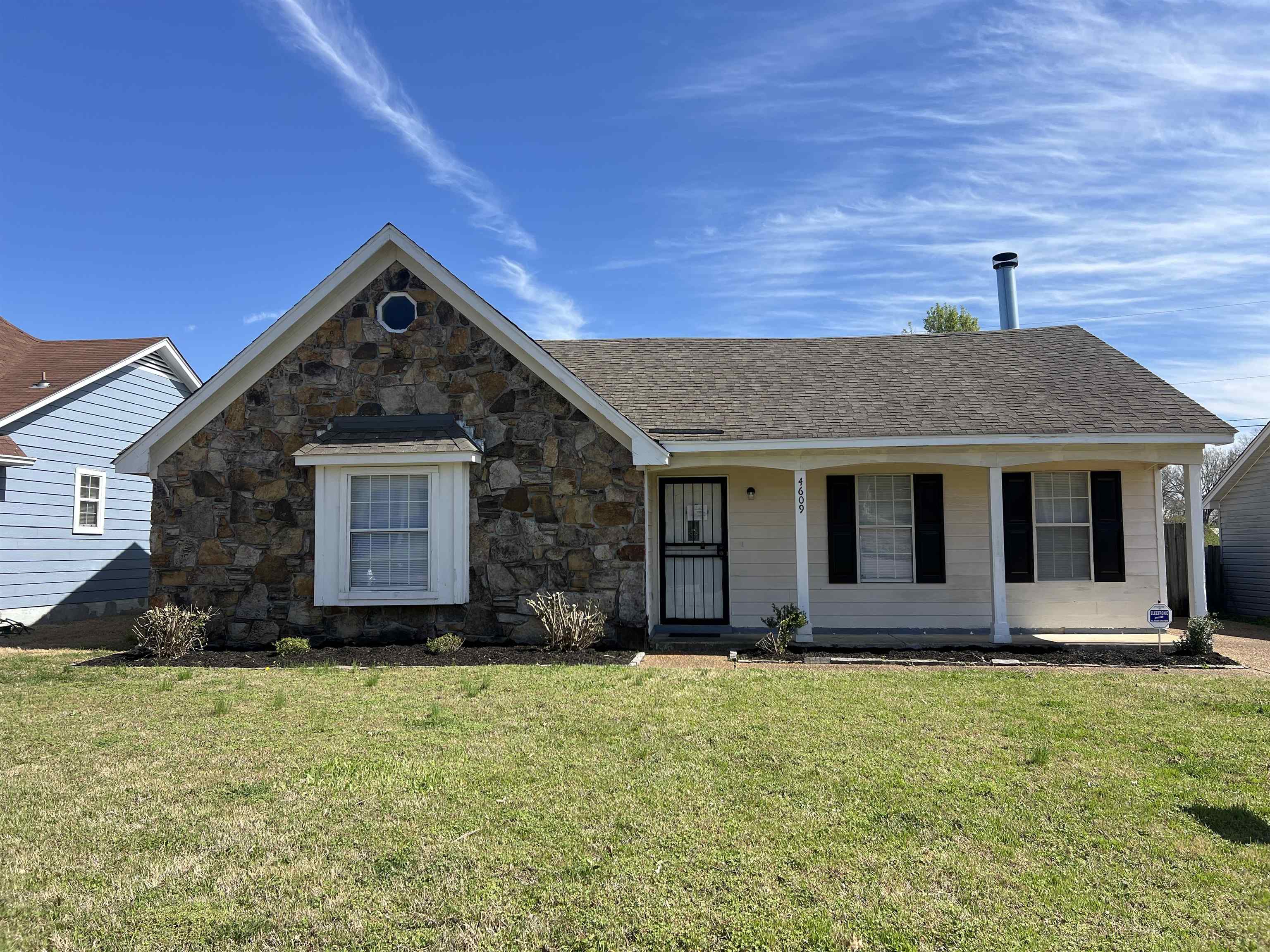 Single story home featuring a front yard and a porch